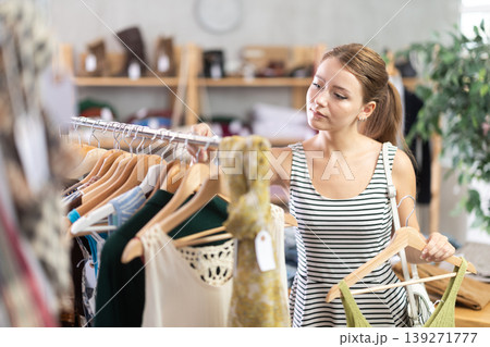woman chooses clothes from the summer collection woman chooses clothes from the summer collection 139271777