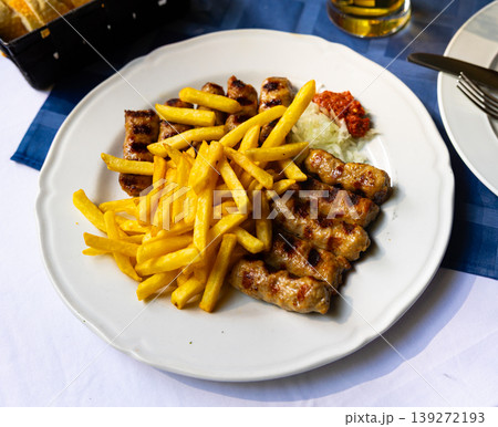 Grilled kebab turkish style barbecued minced meat with sauce. Traditional Balkan food - cevapi or cevapcici Grilled kebab turkish style barbecued minced meat with sauce. Traditional Balkan food - cevapi or cevapcici 139272193