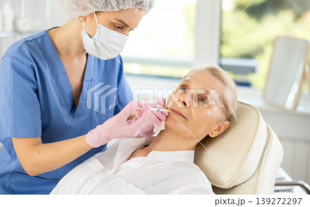 Woman applying rejuvenating treatments by doctor. 139272297