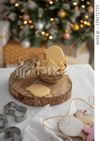 Gingerbread and christmas cookies in a bowl and festive decor on wooden background. Gingerbread and christmas cookies in a bowl and festive decor on wooden background. 139272772