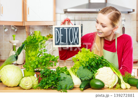 Woman having green diet vegetables, detox sign 139272881