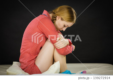 Sad depressed young woman in bed Sad depressed young woman in bed 139272914