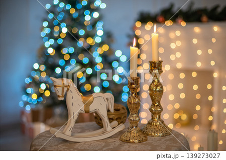 New Year's small table with candles and a toy horse. New Year's small table with candles and a toy horse. 139273027