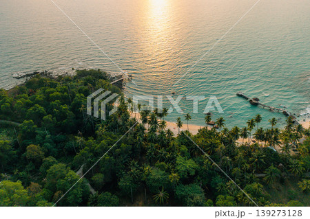 Breathtaking aerial view of a tropical bay during a golden sunset. Breathtaking aerial view of a tropical bay during a golden sunset. 139273128