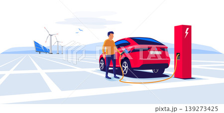 Man Standing and Charging an Electric Car Suv 139273425