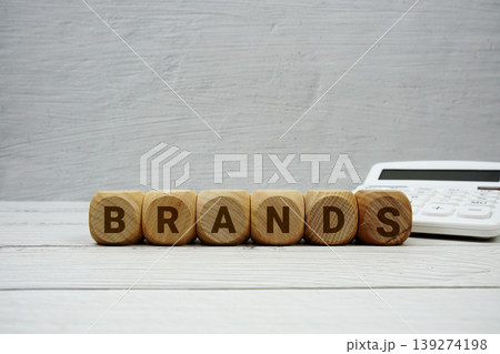 BRANDS alphabet letters with calculator on wooden background 139274198