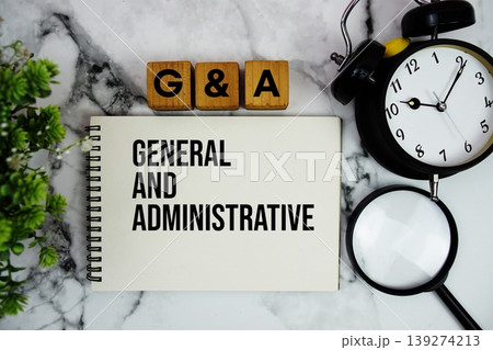 G and A General and Administrative text with alarm clock and magnifying glass on marble background G and A General and Administrative text with alarm clock and magnifying glass on marble background 139274213
