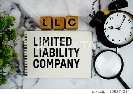 LLC Limited Liability Company text with alarm clock and magnifying glass on marble background 139274214