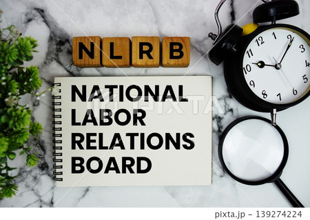 NLRB National Labor Relations Board text with alarm clock and magnifying glass on marble background NLRB National Labor Relations Board text with alarm clock and magnifying glass on marble background 139274224