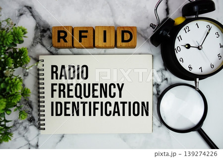 RFID Radio Frequency Identification text with alarm clock and magnifying glass on marble background 139274226