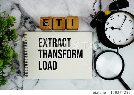 ETL Extract Transform Load text with alarm clock and magnifying glass on marble background 139274255