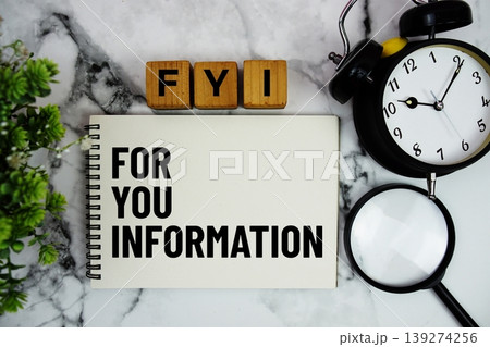 FYI For Your Information text with alarm clock and magnifying glass on marble background FYI For Your Information text with alarm clock and magnifying glass on marble background 139274256