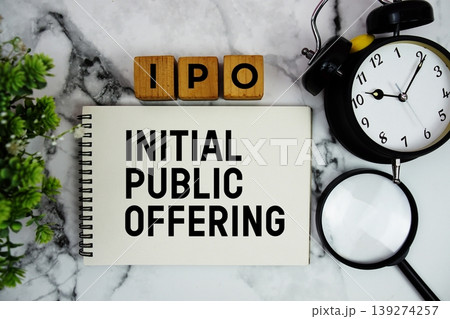 IPO Initial Public Offering text with alarm clock and magnifying glass on marble background IPO Initial Public Offering text with alarm clock and magnifying glass on marble background 139274257