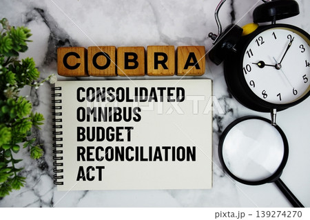 COBRA Consolidated Omnibus Budget Reconciliation Act text with alarm clock and magnifying glass on marble background COBRA Consolidated Omnibus Budget Reconciliation Act text with alarm clock and magnifying glass on marble background 139274270