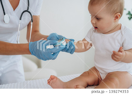 In the clinic. Female doctor is taking care of little baby girl 139274353
