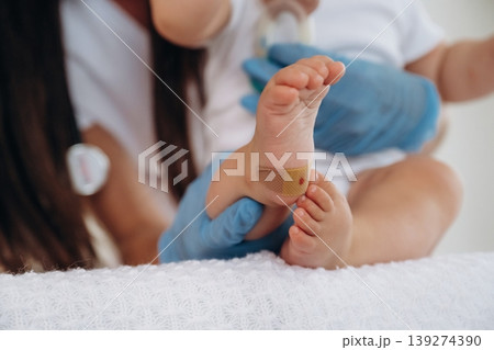 Close up view of little baby girl that is in appointment with doctor Close up view of little baby girl that is in appointment with doctor 139274390