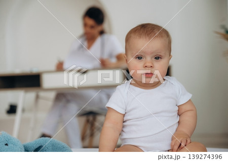 Female doctor is taking care of little baby girl in the clinic Female doctor is taking care of little baby girl in the clinic 139274396