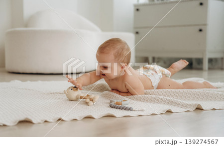 Playful happy little baby is at home in domestic room 139274567