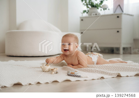 Playful happy little baby is at home in domestic room 139274568