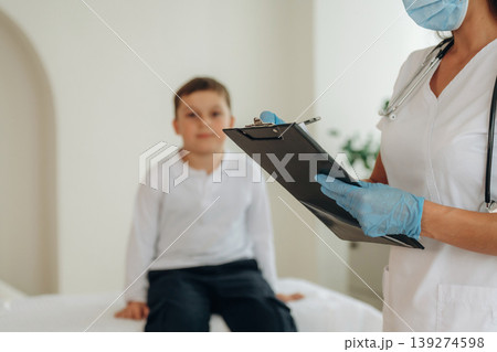 Boy is in routine appointment in clinic with female doctor 139274598