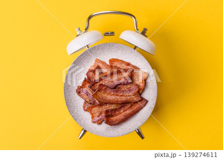 Fried fresh bacon slices with layers of meat or prosciutto prepared for breakfast. Fried bacon 139274611