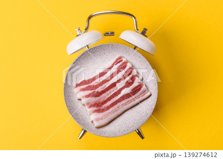 Raw fresh bacon slices with layers of meat or prosciutto prepared for frying. Raw bacon 139274612