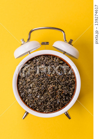 Granules of dried organic Chinese green tea with herbal additives. Dry green tea 139274617