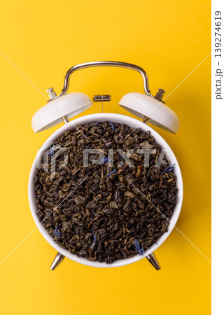 Granules of dried organic Chinese green tea with herbal additives. Dry green tea 139274619