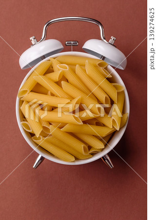 Italian uncooked dry penne regate pasta ready for cooking. Dry penne pasta Italian uncooked dry penne regate pasta ready for cooking. Dry penne pasta 139274625