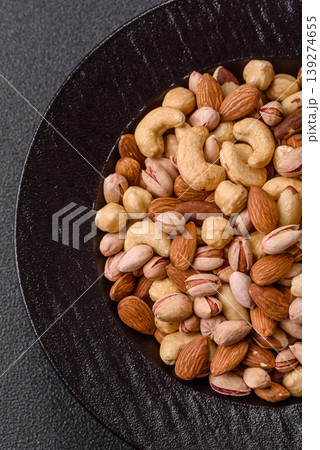 A mix of cashews, pistachios, almonds, macadamia and hazelnuts. Nuts as a food background 139274655
