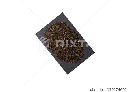 Granules of dried organic Chinese green tea with herbal additives. Dry green tea Granules of dried organic Chinese green tea with herbal additives. Dry green tea 139274692