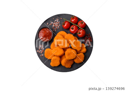 Fried chicken nuggets with sauce, salt, and spices, fast food, unhealthy food. Chicken nuggets Fried chicken nuggets with sauce, salt, and spices, fast food, unhealthy food. Chicken nuggets 139274696