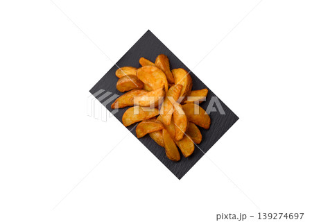 Potato wedges baked with garlic, herbs, and spices for lunch. Potato wedges Potato wedges baked with garlic, herbs, and spices for lunch. Potato wedges 139274697