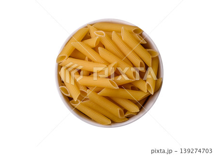 Italian uncooked dry penne regate pasta ready for cooking. Dry penne pasta Italian uncooked dry penne regate pasta ready for cooking. Dry penne pasta 139274703