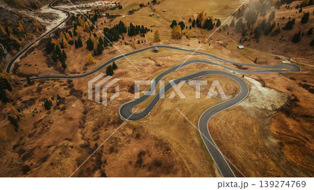 Twisted snake-like asphalt road. Pass near Cortina mountain. Aerial majestic view of popular place at autumn season, background Twisted snake-like asphalt road. Pass near Cortina mountain. Aerial majestic view of popular place at autumn season, background 139274769