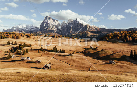 Place to live peaceful life, wooden houses. Alpe di Siusi, Seiser Alm, aerial view of majestic dolomites, mountains background Place to live peaceful life, wooden houses. Alpe di Siusi, Seiser Alm, aerial view of majestic dolomites, mountains background 139274814