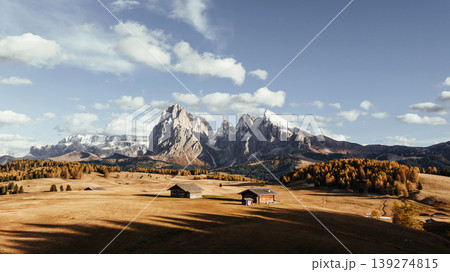 Place to live peaceful life, wooden houses. Alpe di Siusi, Seiser Alm, aerial view of majestic dolomites, mountains background Place to live peaceful life, wooden houses. Alpe di Siusi, Seiser Alm, aerial view of majestic dolomites, mountains background 139274815