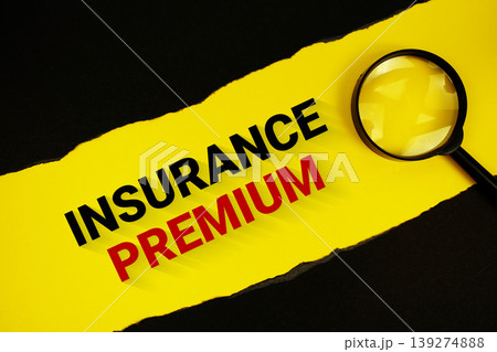 Insurance Premium text on yellow with black paper torn ripped and magnifying glass 139274888