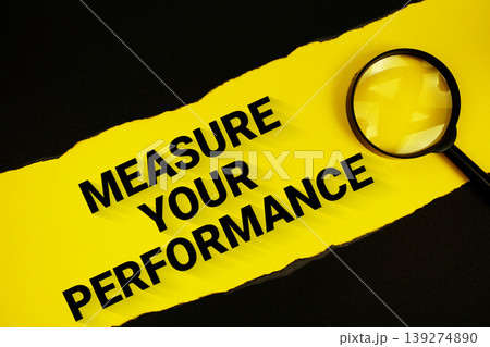 Measure Your Performance text on yellow with black paper torn ripped and magnifying glass 139274890
