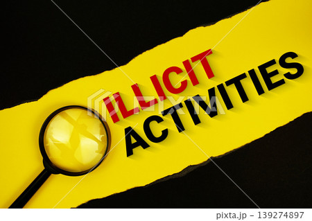 Illicit Activities text on yellow with black paper torn ripped and magnifying glass Illicit Activities text on yellow with black paper torn ripped and magnifying glass 139274897