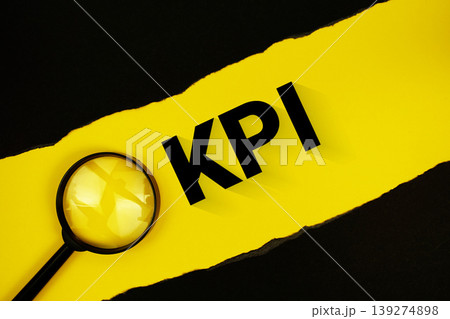 KPI Key Performance Indicator text on yellow with black paper torn ripped and magnifying glass 139274898