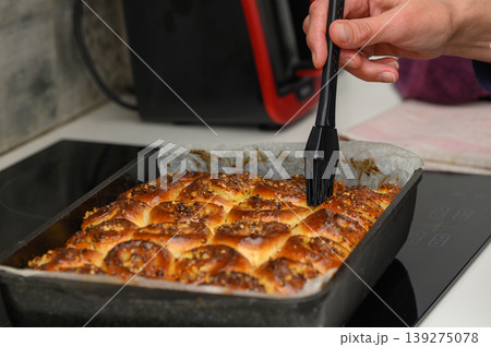 Baking freshly prepared pastries in a cozy kitchen during a weekend gathering with family and friends Baking freshly prepared pastries in a cozy kitchen during a weekend gathering with family and friends 139275078