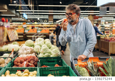 A senior man is buying food in the grocery store 139275244