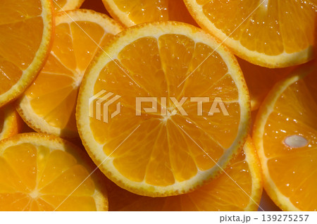 Bright orange citrus slices arranged artfully on a white surface in a vibrant Bright orange citrus slices arranged artfully on a white surface in a vibrant 139275257