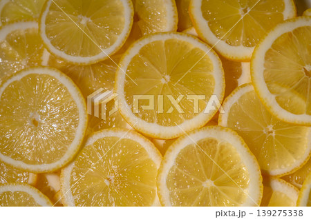 Slices of fresh lemons arranged beautifully on a bright surface capturing Slices of fresh lemons arranged beautifully on a bright surface capturing 139275338