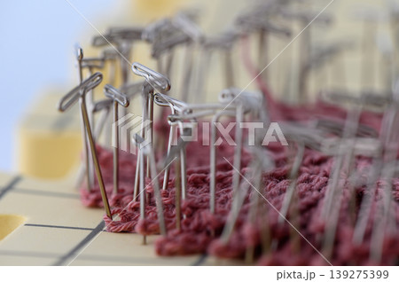 Pinning Wet Knitted Fabric for Blocking on White Background 139275399