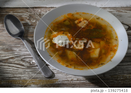 Delicious homemade soup served in a white bowl on a rustic wooden table during Delicious homemade soup served in a white bowl on a rustic wooden table during 139275418