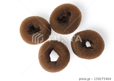 Set of Four Brown Hair Bun Maker Donut Sponges Isolated on White Background Set of Four Brown Hair Bun Maker Donut Sponges Isolated on White Background 139275464