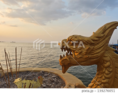 Golden dragon statue incense sea sunset sky peaceful Golden dragon statue incense sea sunset sky peaceful 139276051