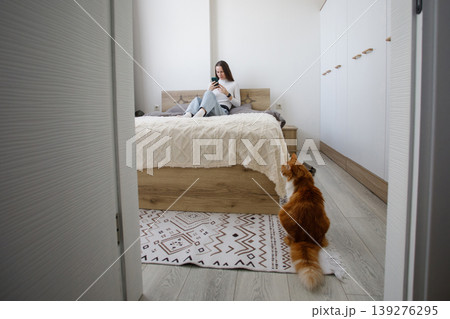 Cute woman using smartphone at home 139276295